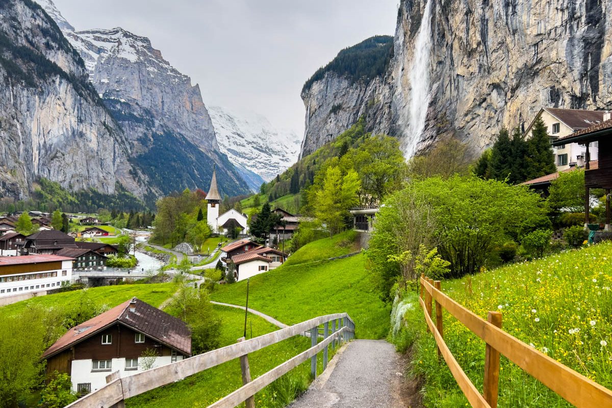 Lauterbrunnen, Switzerland; May 5 2024: Beautiful spring day in Lauterbrunnen, Switzerland, featuring stunning waterfalls, mountain views, and charming village scenery. 4K UHD